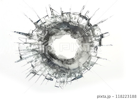 A close-up of a bullet hole in a windshield, with glass shards frozen in time. 118223188