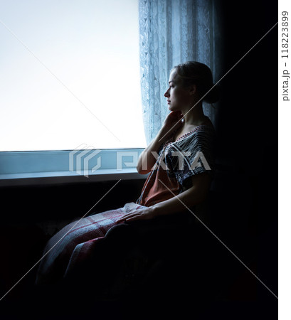 Disabled person in stroller by window 118223899