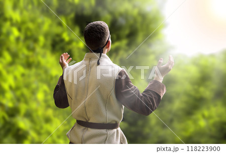 Praying man with raised hands 118223900