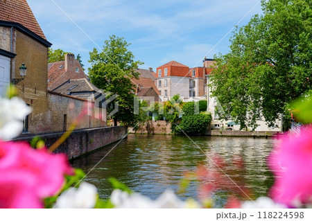 Scenic canal with colorful flowers and historic buildings in the background 118224598