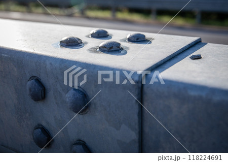 Close-up of large metal screws on tin cover, engineering solutions 118224691
