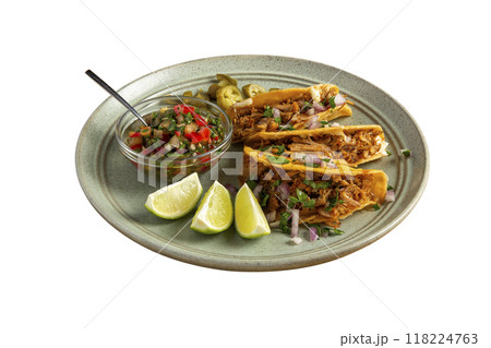 Delicious tacos filled with meat served on a plate. 118224763
