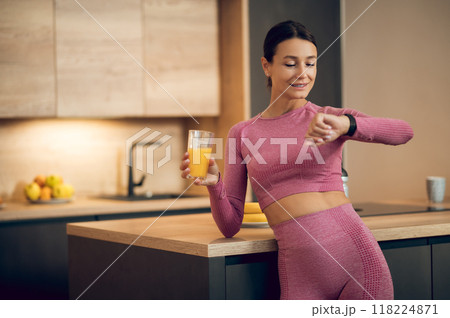 Sporty beautiful woman looking at her smartwatch tracking fitness results after fitness workout Sporty beautiful woman looking at her smartwatch tracking fitness results after fitness workout 118224871