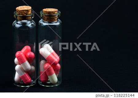 glass jar with colorful pills 118225144
