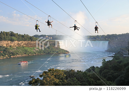Tourists enjoying zipline ride at Niagara Falls in summer, Canada 118226099