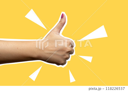 A hand giving a thumbs up on a yellow background 118226537
