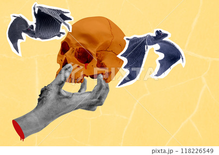 Hand holding human head skull with bats flying around it Hand holding human head skull with bats flying around it 118226549