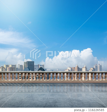 A city skyline with a clear blue sky and a few clouds 118226585