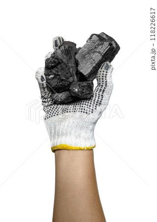 A person is holding a handful of coal in their gloved hands A person is holding a handful of coal in their gloved hands 118226617
