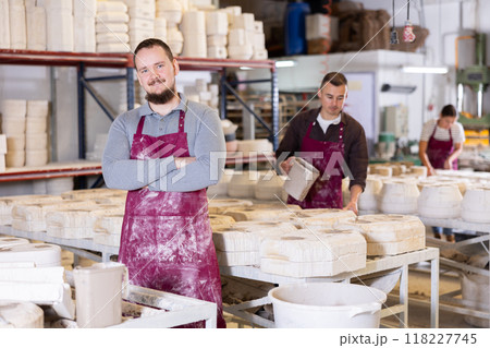 Successful ceramicist standing in pottery slip casting workshop Successful ceramicist standing in pottery slip casting workshop 118227745