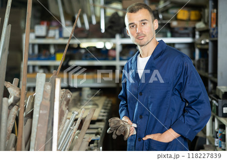 Man employee of carpentry workshop took time out from work, stands resting 118227839