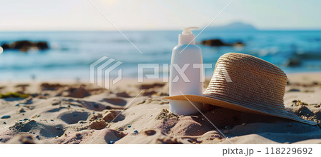Summer straw hat and sunscreen cream lotion, beach sand. Sunbathing, skincare, UV rays sun protection, vacation, leisure near the sea concept 118229692