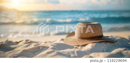 Summer straw hat on beach sand near the sea. Vacation, leisure, Sunbathing and relaxing concept 118229694