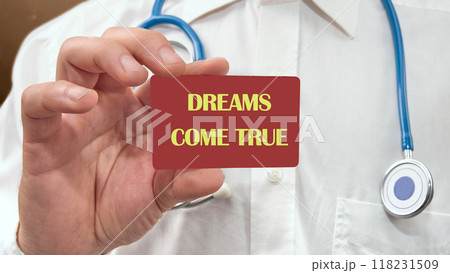 Conceptual dreams come true symbol. Copy space. Dreams come true words on the red card in the man's hand 118231509