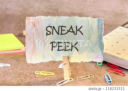 Conceptual sneak peek symbol. Copy space. SNEAK PEEK words written on a piece of paper in a clothespin Conceptual sneak peek symbol. Copy space. SNEAK PEEK words written on a piece of paper in a clothespin 118231511