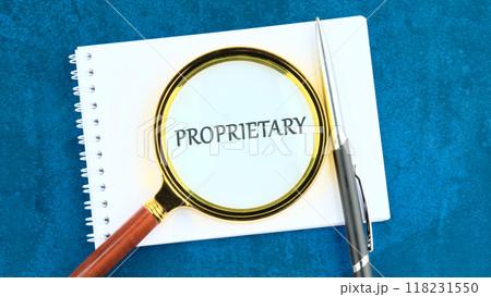 Letters of the alphabet with words PROPRIETARY through a magnifying glass on a blank sheet of notepad Letters of the alphabet with words PROPRIETARY through a magnifying glass on a blank sheet of notepad 118231550