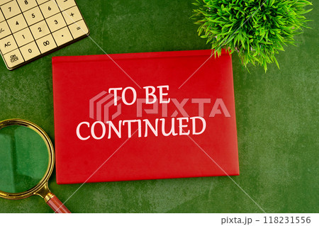 TO BE CONTINUED text written on the red book, business on a green saturated background 118231556