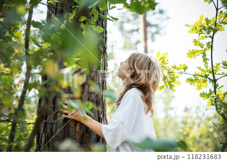 Teenager girl hugging tree. Teenager girl hugging tree. 118231683