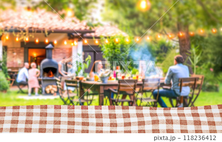 summer time party with family in backyard garden with grill BBQ, Kitchen table with fabric, blurred background summer time party with family in backyard garden with grill BBQ, Kitchen table with fabric, blurred background 118236412