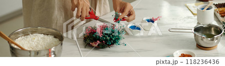 Woman Decorating Candles With Flowers 118236436