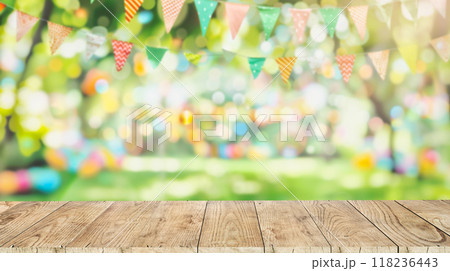 Empty wooden table with party in backyard, blurred background with festive bunting Empty wooden table with party in backyard, blurred background with festive bunting 118236443
