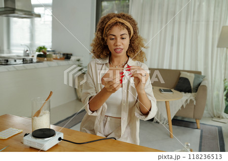 Woman Using Wick To Make Handmade Candles Woman Using Wick To Make Handmade Candles 118236513
