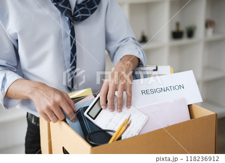 Businessman Packing Personal Belongings in Office After Resignation or Job Loss Businessman Packing Personal Belongings in Office After Resignation or Job Loss 118236912