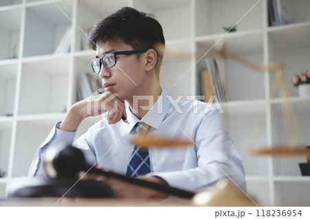 Lawyer Reviewing Legal Documents at Office Desk Lawyer Reviewing Legal Documents at Office Desk 118236954