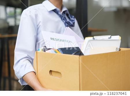 Businessman Leaving Office After Resignation with Box of Belongings Businessman Leaving Office After Resignation with Box of Belongings 118237041