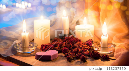 Candles and dried rosebuds on the table 118237550