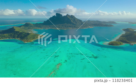 Stunning Bora Bora with its iconic mount otemanu, green islands and turquoise lagoon, creating a picture of perfect tropical paradise. Popular tourist destination. Aerial view drone travel background 118238401