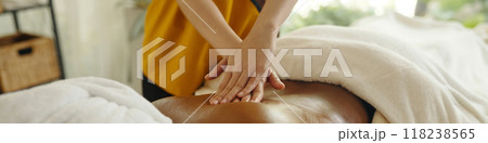 Receiving Relaxing Back Massage at Wellness Spa Receiving Relaxing Back Massage at Wellness Spa 118238565