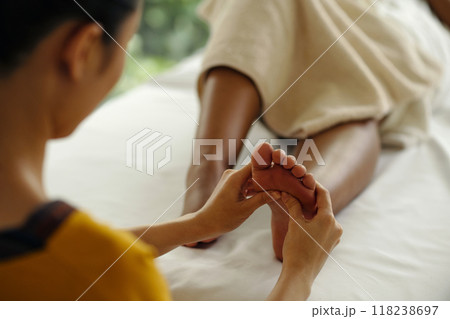 Providing Relaxing Foot Massage in Tranquil Environment 118238697
