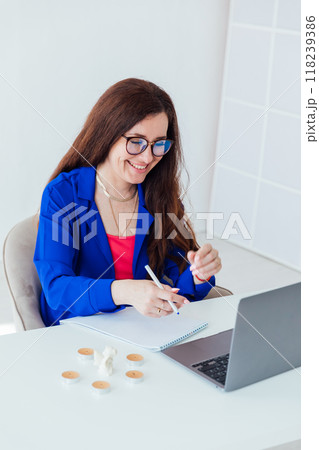 Business woman smiling at work in office using online laptop 118239386