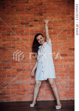 Beautiful woman in a dress raised her hand up Beautiful woman in a dress raised her hand up 118239503
