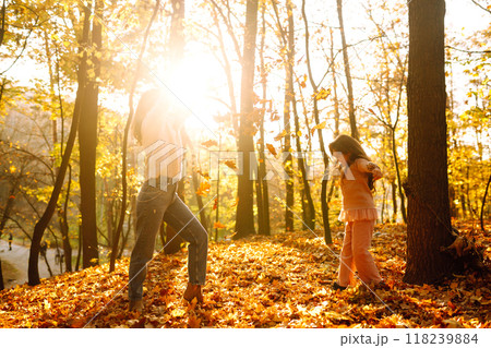Portrait of happy mother and daughter in autumn forest at sunset. . Autumn women. 118239884