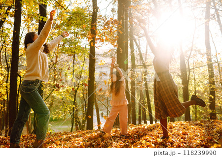 The homosexual family playing with her daughter in the autumn forest. The adventure is more fun. 118239990