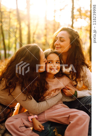 The homosexual family playing with her daughter in the autumn forest. The adventure is more fun. The homosexual family playing with her daughter in the autumn forest. The adventure is more fun. 118239998