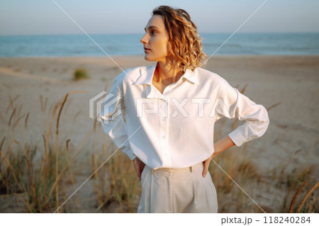 Stylish woman enjoying autumn weather outdoor. Fashion, style concept. People, lifestyle, relaxation 118240284