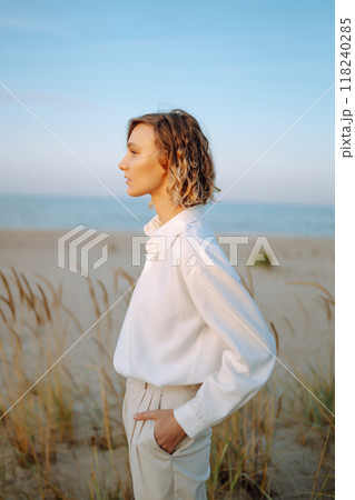 Stylish woman enjoying autumn weather outdoor. Fashion, style concept. People, lifestyle, relaxation 118240285