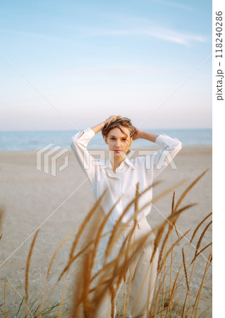 Stylish woman enjoying autumn weather outdoor. Fashion, style concept. People, lifestyle, relaxation 118240286