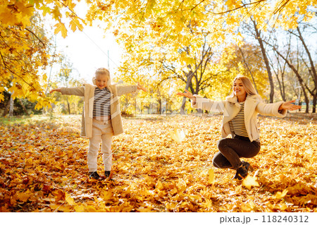 Young Mother and daughter walking in the park and enjoying the beautiful autumn nature. Walk, family 118240312