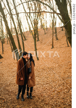 Young couple in love walking in the park on a autumn day. Enjoying time together. 118240682