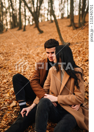 Young couple in love walking in the park on a autumn day. Enjoying time together. Young couple in love walking in the park on a autumn day. Enjoying time together. 118240701