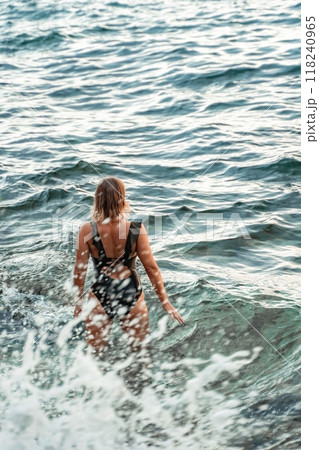 Woman Ocean Water - A woman swims in the ocean, facing the waves. Woman Ocean Water - A woman swims in the ocean, facing the waves. 118240965