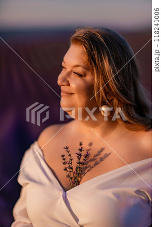 woman poses in lavender field at sunset. Happy woman in white dress holds lavender bouquet. Aromatherapy concept, lavender oil, photo session in lavender woman poses in lavender field at sunset. Happy woman in white dress holds lavender bouquet. Aromatherapy concept, lavender oil, photo session in lavender 118241006