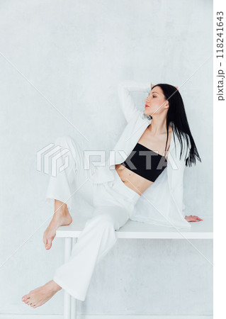 Beautiful slim fashion brunette woman in white business suit 118241643