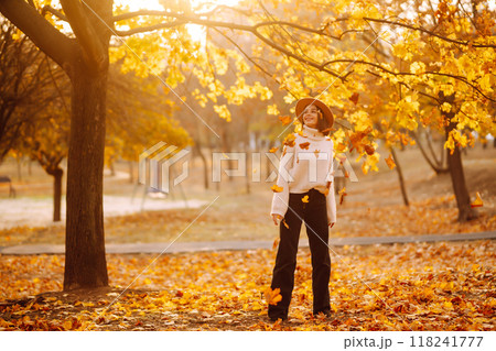 Stylish woman enjoying autumn weather in the park. Fashion, style concept. 118241777