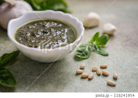 Close-up of bowl of fresh pesto sauce with ingredients, copy space Close-up of bowl of fresh pesto sauce with ingredients, copy space 118241954