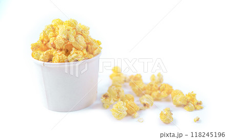 Isolated image of popcorn in a paper cup set against a white background, showcasing the fluffy, golden kernels spilling over the edges, perfect for themes related to snacks, cinema, or casual dining. Isolated image of popcorn in a paper cup set against a white background, showcasing the fluffy, golden kernels spilling over the edges, perfect for themes related to snacks, cinema, or casual dining. 118245196